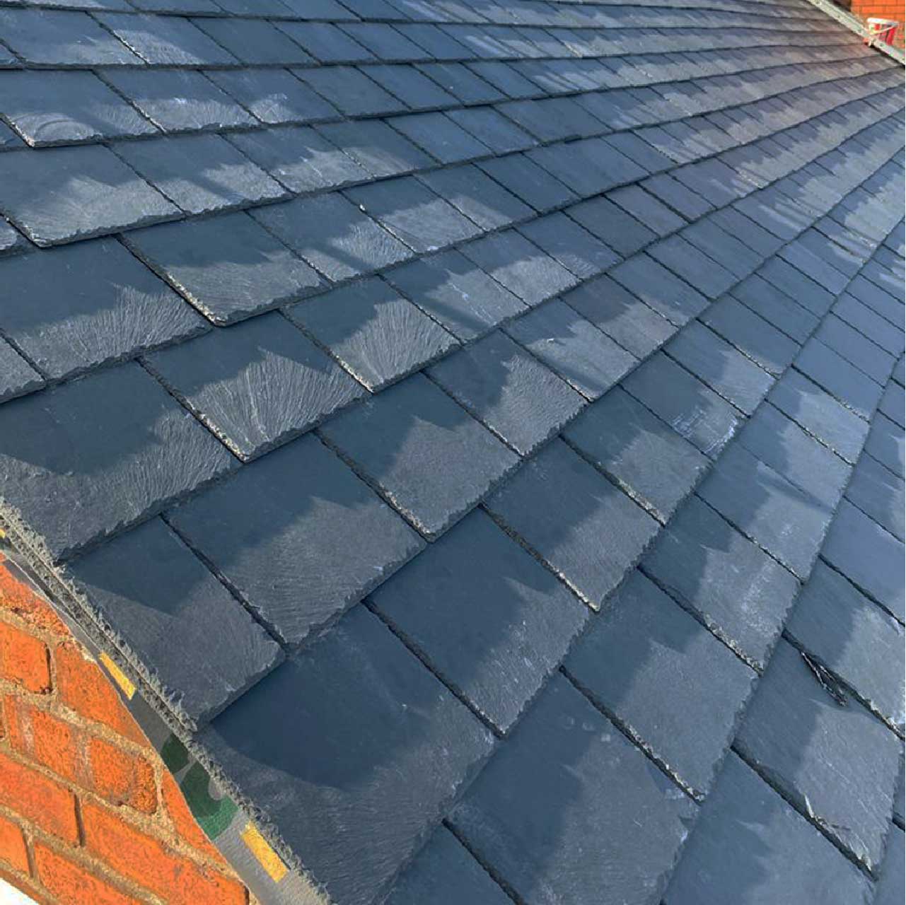 Madog Grey roofing slate on a roof, close up to show slates in detail.